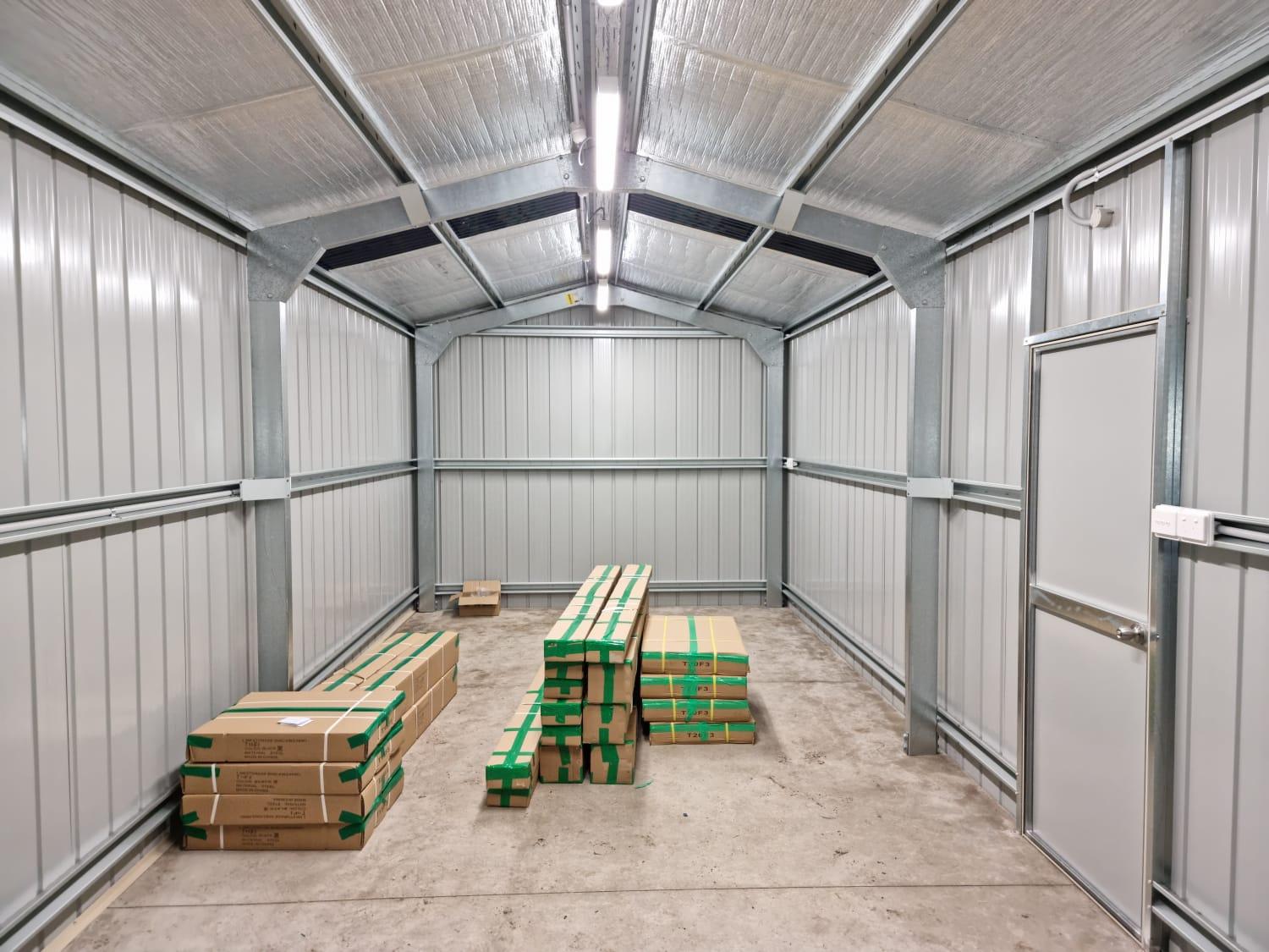 Modern backyard shed with professional electrical installation and lighting.