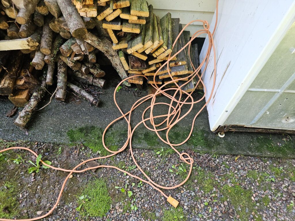 Comparison between temporary extension cord power and professionally installed shed electrical wiring.